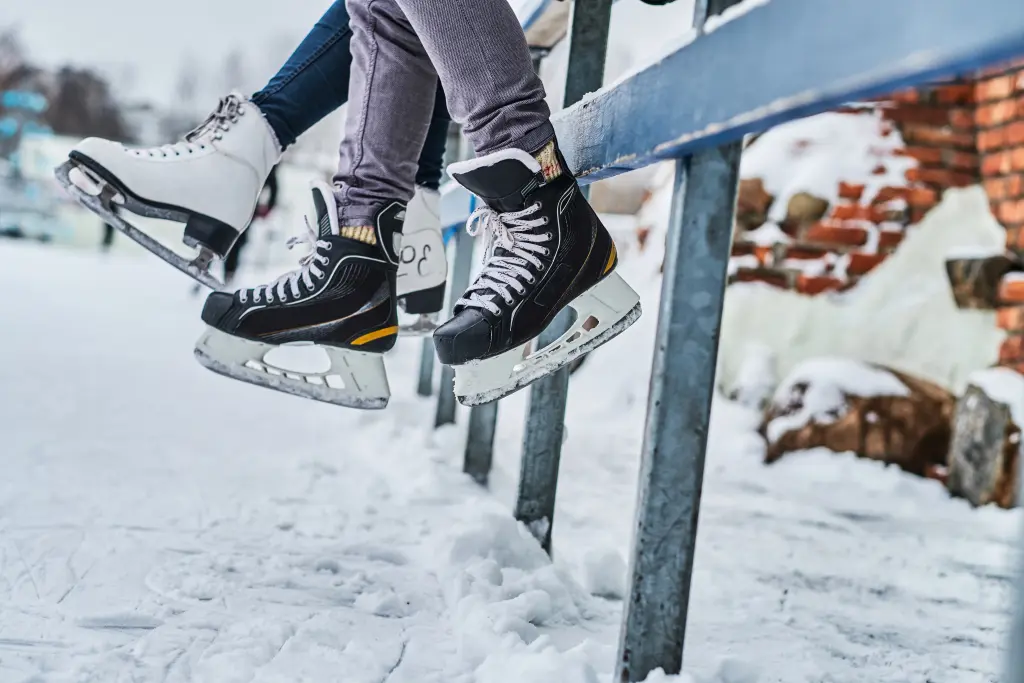 couple-wearing-ice-skates-sitting-guardrail-dating-ice-rink-close-up-view-skates.jpg couple-wearing-ice-skates-sitting-guardrail-dating-ice-rink-close-up-view-skates.jpg